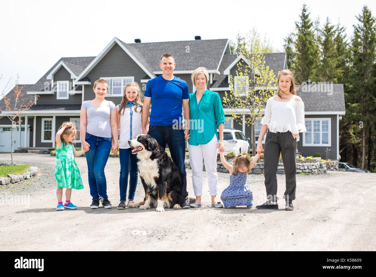 happy family standing in front of the house Stock Photo - Alamy