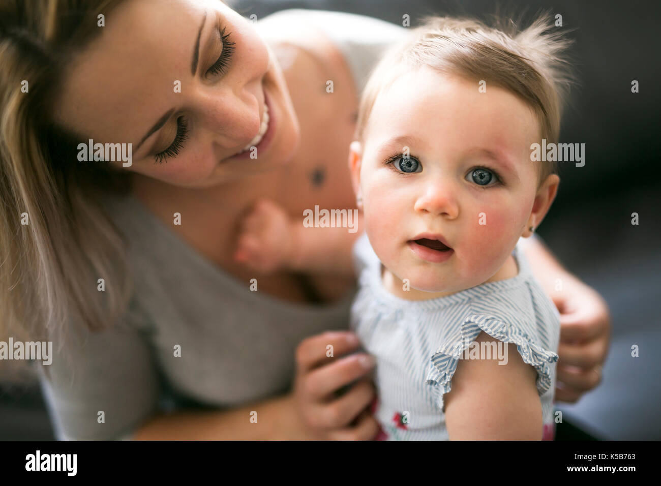 Mother carrying baby girl hi-res stock photography and images - Alamy