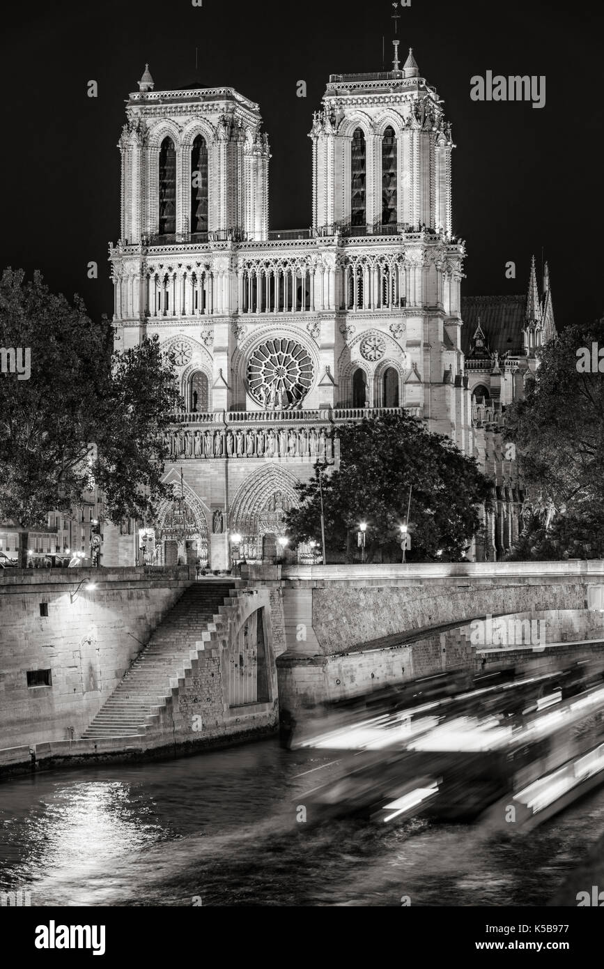 Notre Dame de Paris cathedral at night with the Seine River Black and White). Ile de La Cite. Paris, France Stock Photo