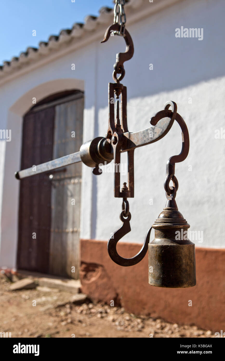 Hanging antique roman steelyard on a farm house, Badajoz, Spain Stock Photo