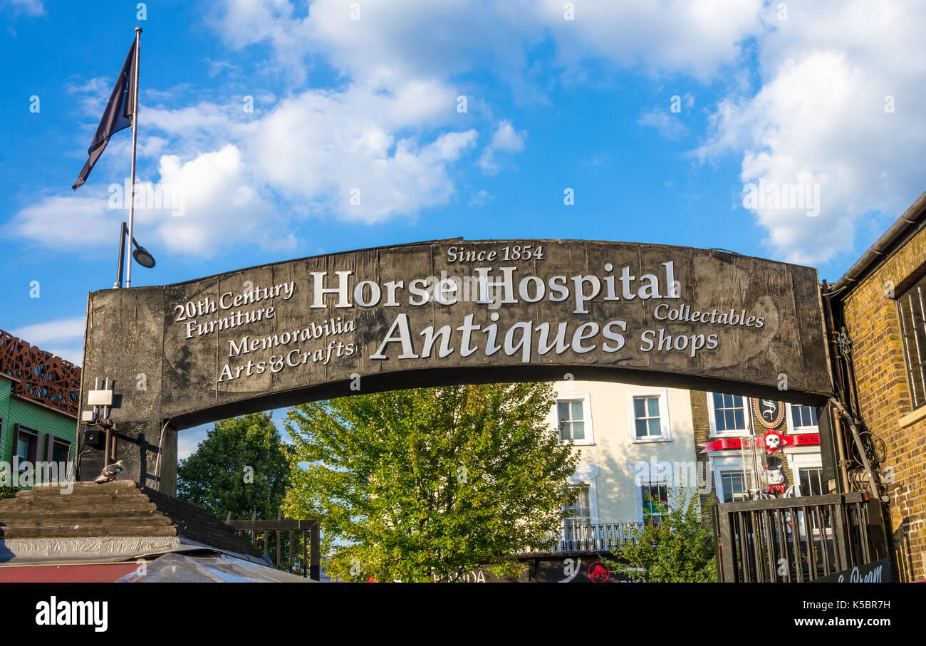 A sign  for 'Horse Hospital Antiques' against a blue sky in Camden Market, London. Stock Photo