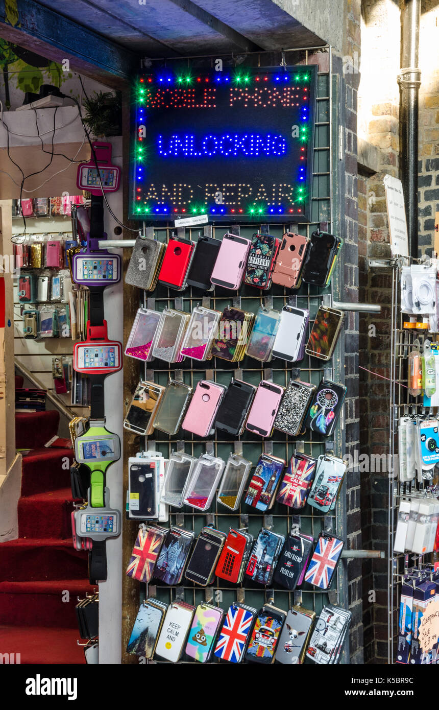 A rack with mobile phone cases and accessories displayed outside a store. Stock Photo