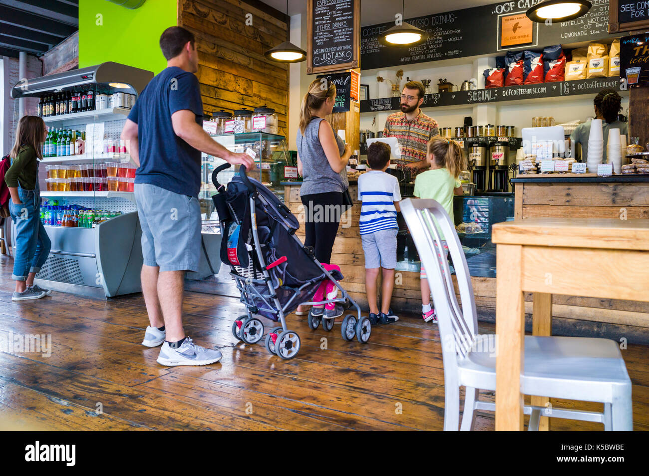 Patrons at a coffee shop in a large metropolitan city Stock Photo