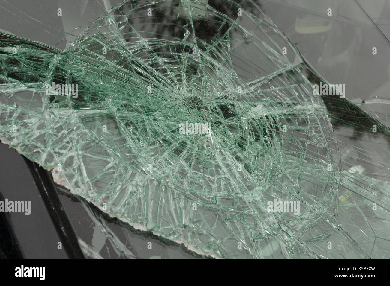 Smashed windscreen or windshield on a car in close up ideal for vehicle insurance claim or vandalism concepts Stock Photo