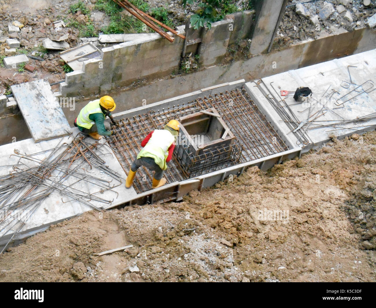 SELANGOR, MALAYSIA -MARCH 18, 2017: Construction workers install precast underground drain at the construction site. Stock Photo