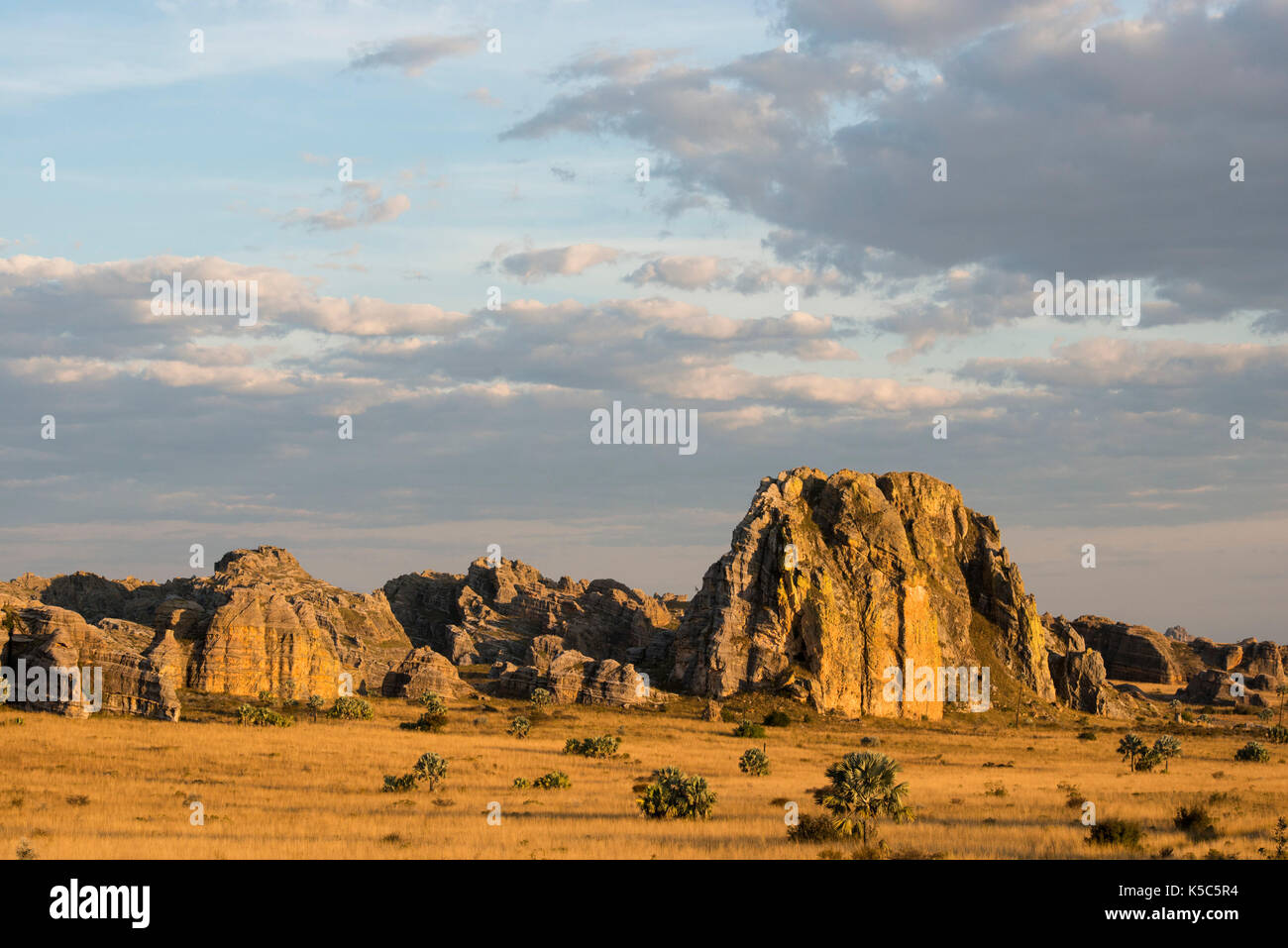 Sandstone formations jutting out from grassland, Isalo National Park, Madagascar Stock Photo
