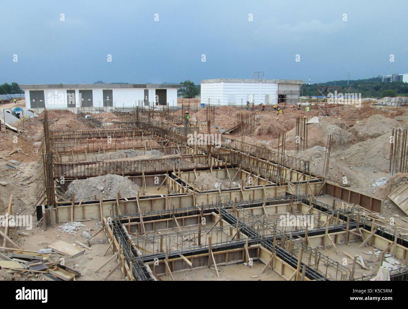 Building ground beam under construction. Made from steel reinforced concrete and the mold made from timber and plywood. Constructed by workers. Stock Photo