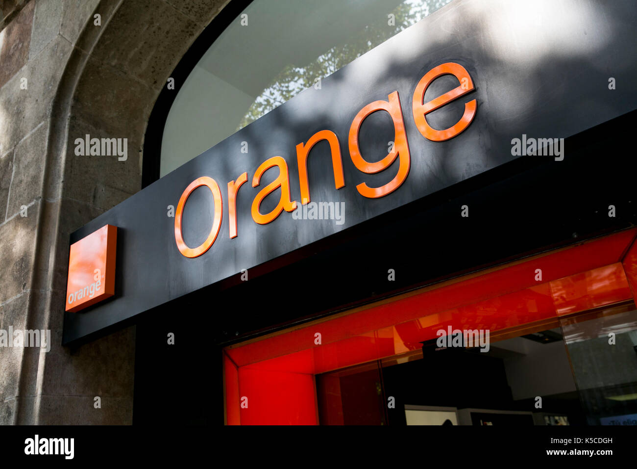 A logo sign outside of a Orange S.A., retail store in Barcelona, Spain