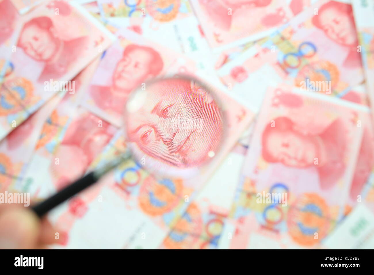 one hundred dollar zoom magnifying glass Stock Photo