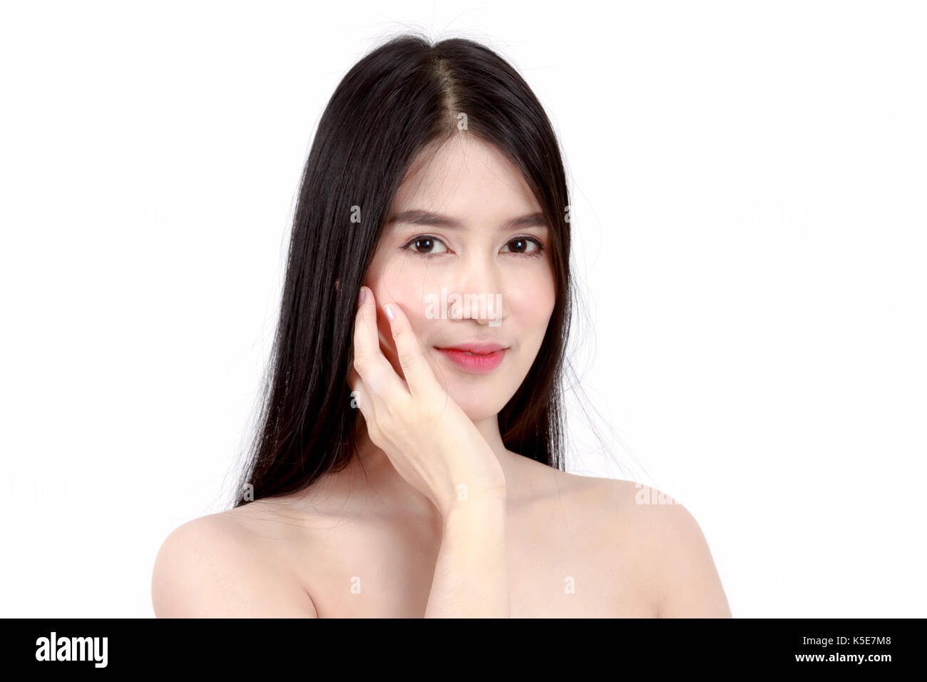 Young Asian woman touching her face and smile Stock Photo - Alamy