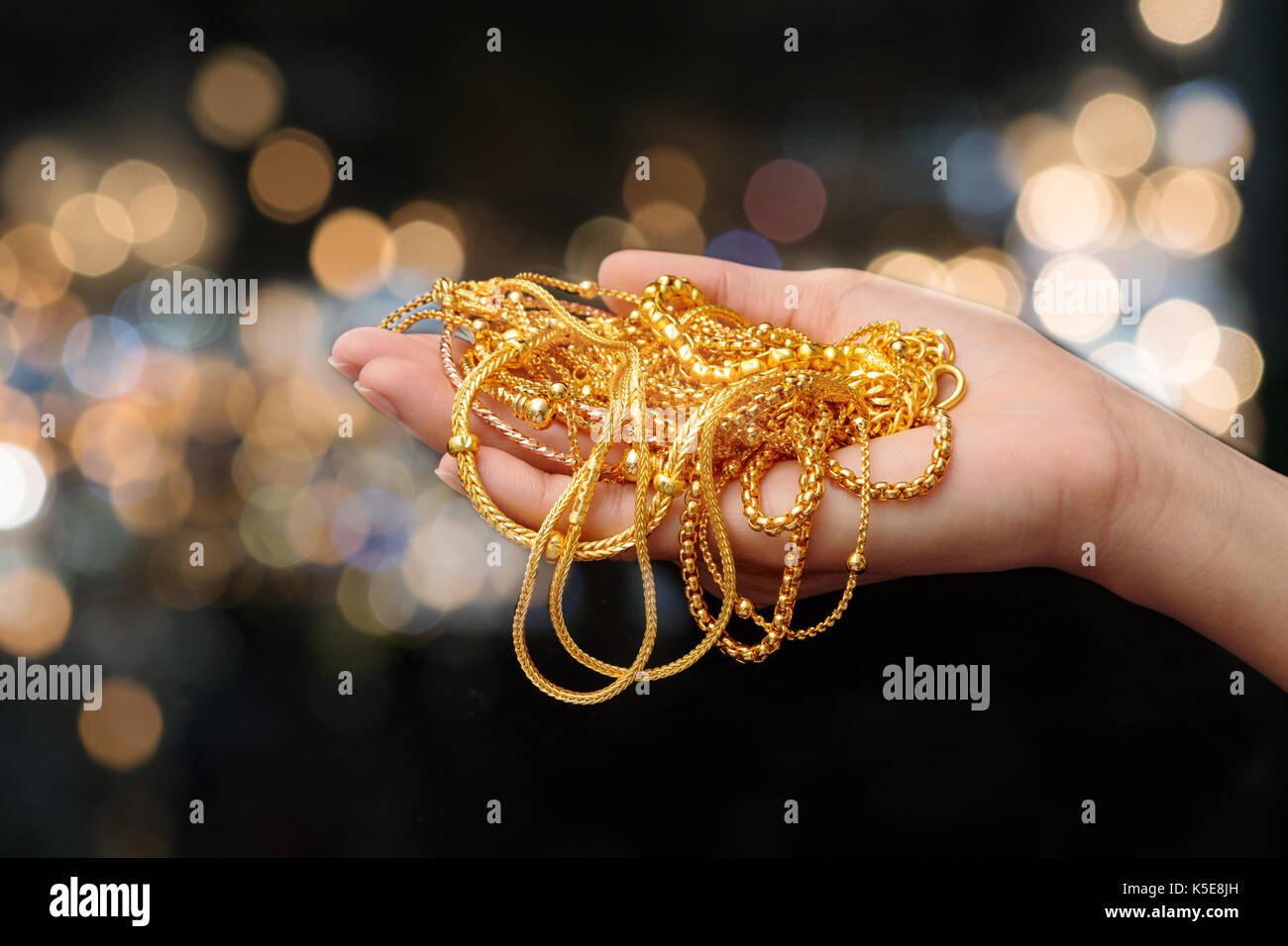 woman hand hold gold bracelet and necklace jewelry Stock Photo Alamy