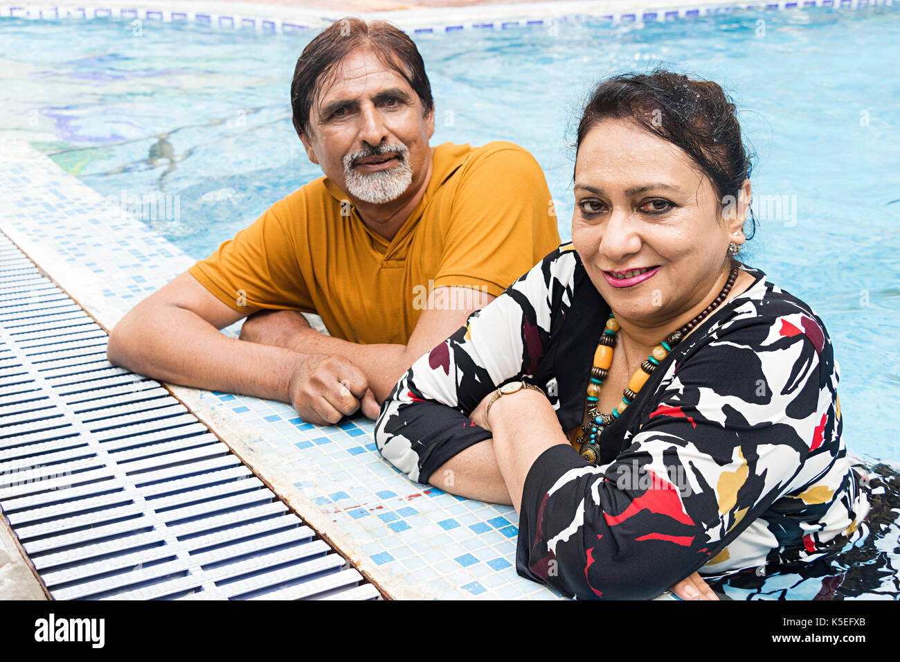 2 senior couple bathing in swimming pool Hotel Enjoy Summer Day Stock Photo
