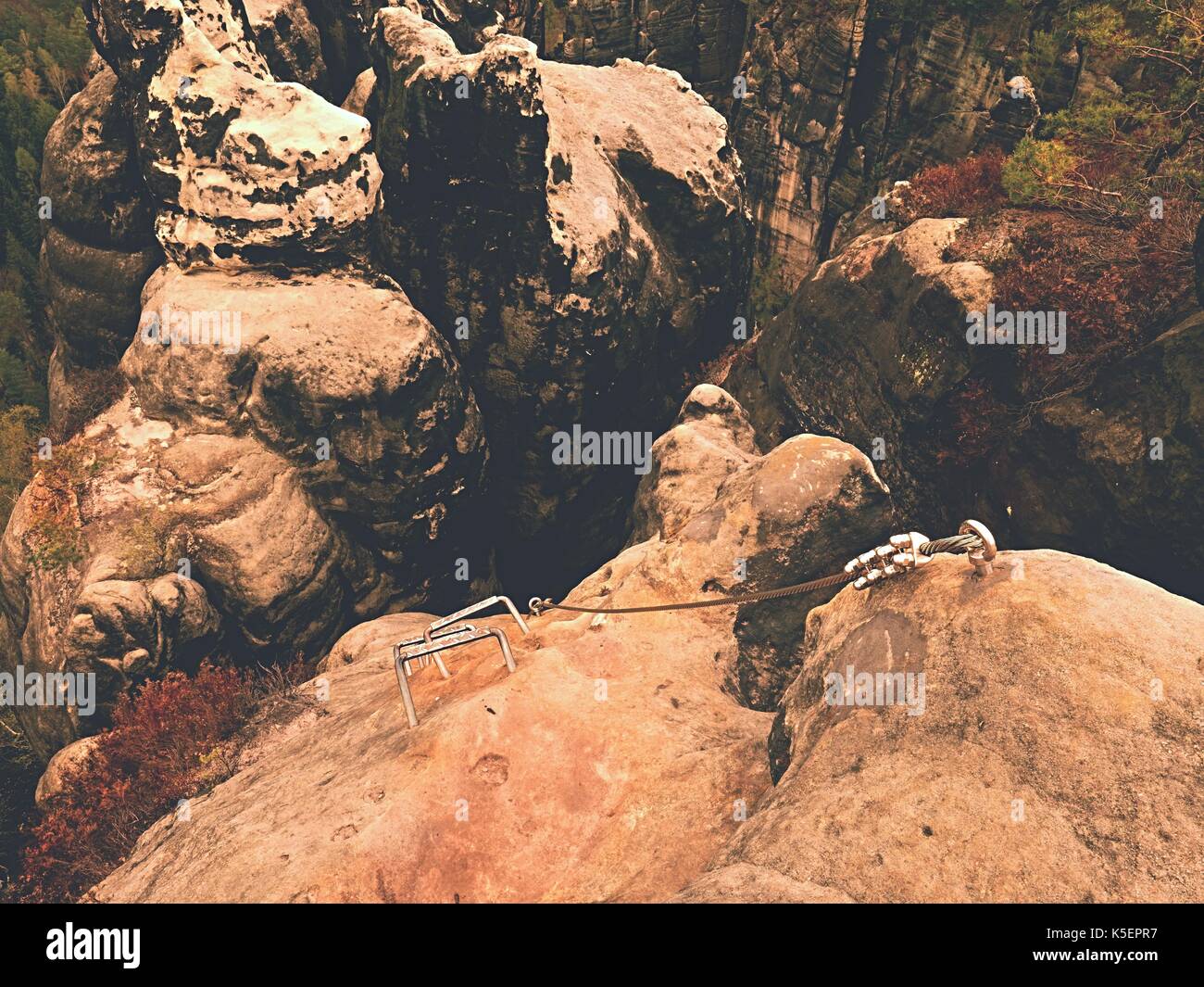 Climbers ladder. Iron twisted rope fixed in block by screws snap hooks