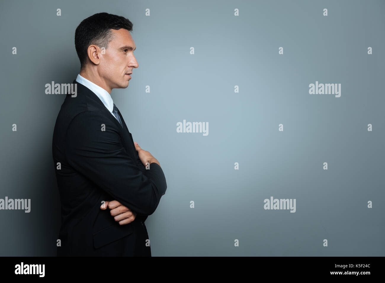 Serious nice man looking in front of him Stock Photo