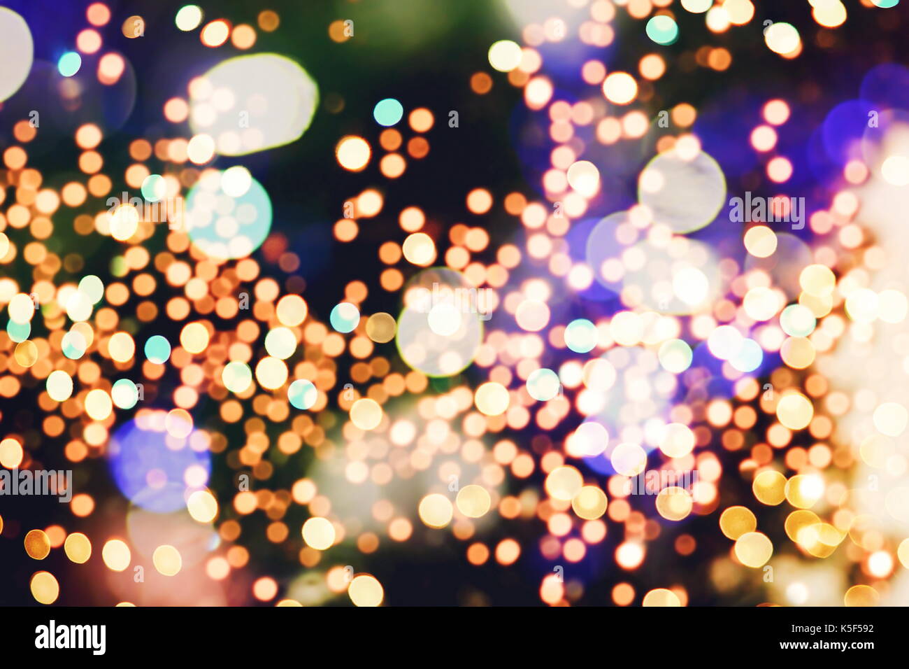 Festive background with natural bokeh and bright golden lights. Vintage ...