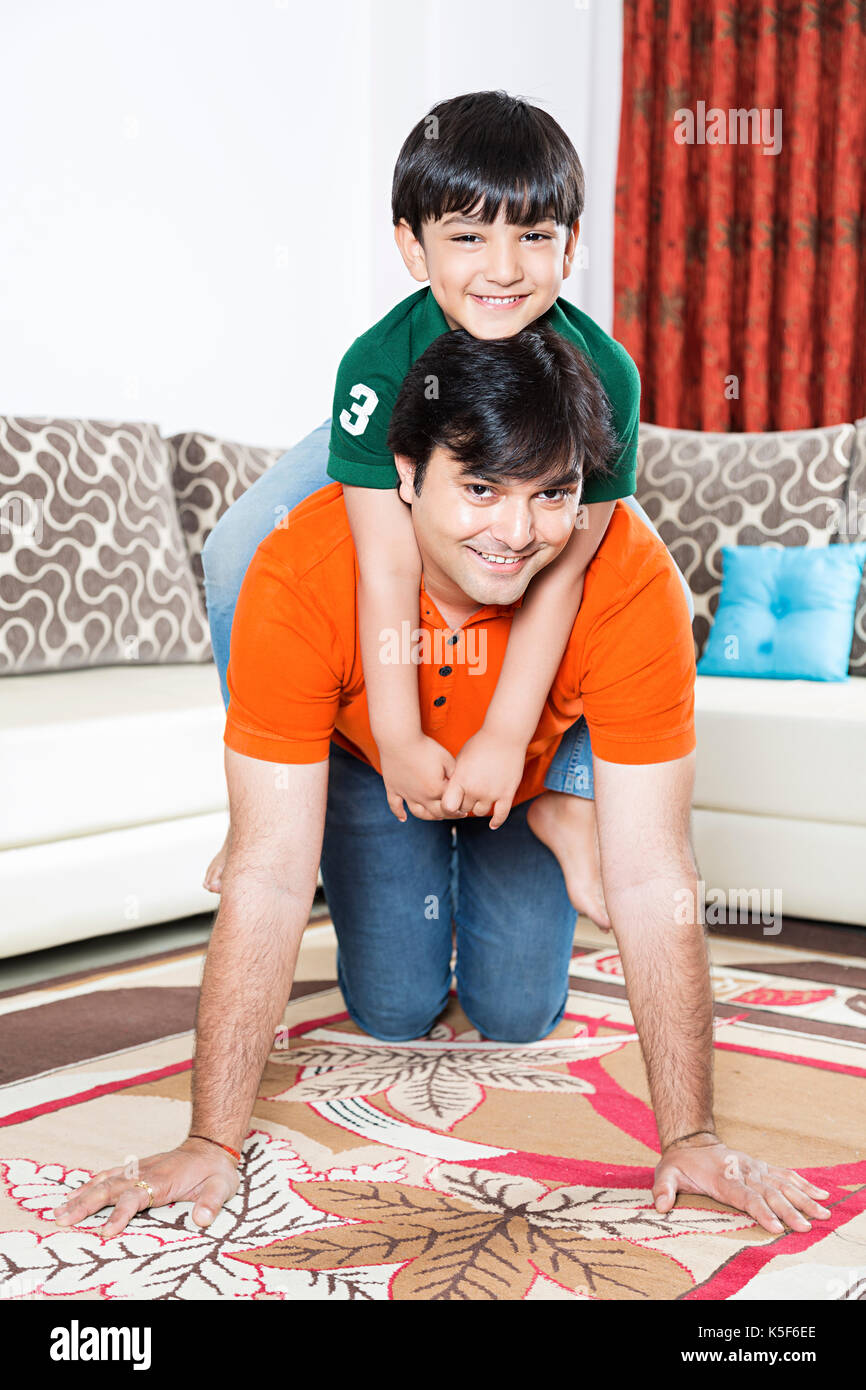 Father And Kid Boy Ride Piggyback At Home Stock Photo