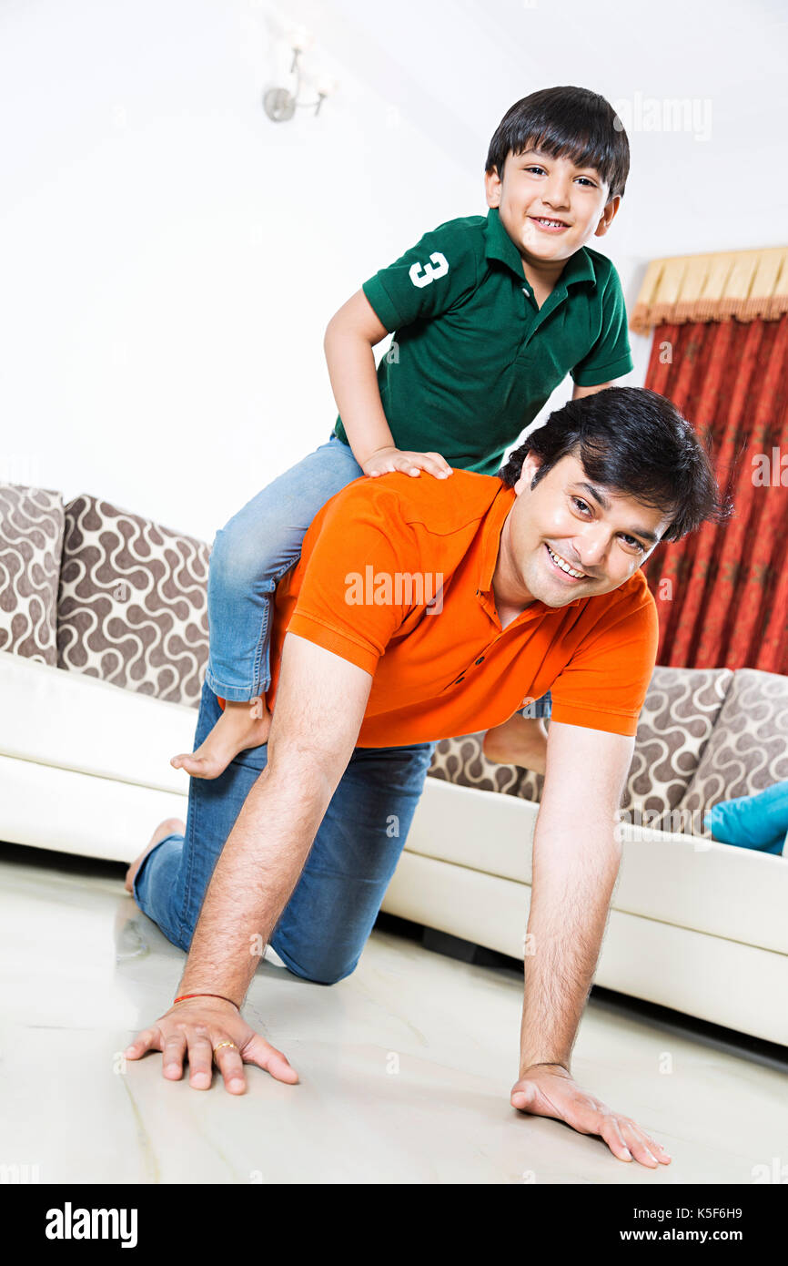 Father And Kid Boy Ride Piggyback Having Fun Playful At Home Stock Photo