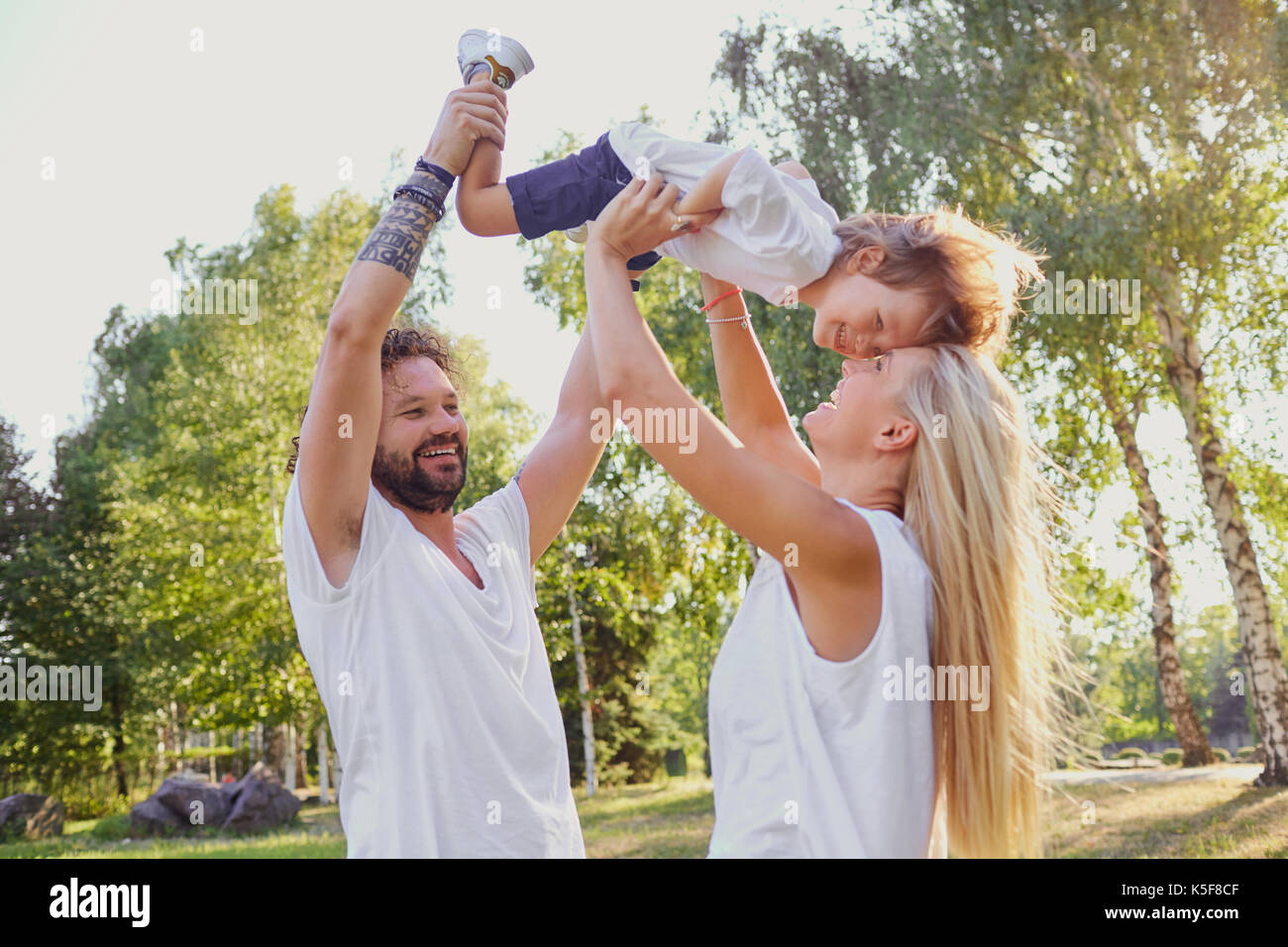 Happy family laughing outdoors hi-res stock photography and images - Alamy