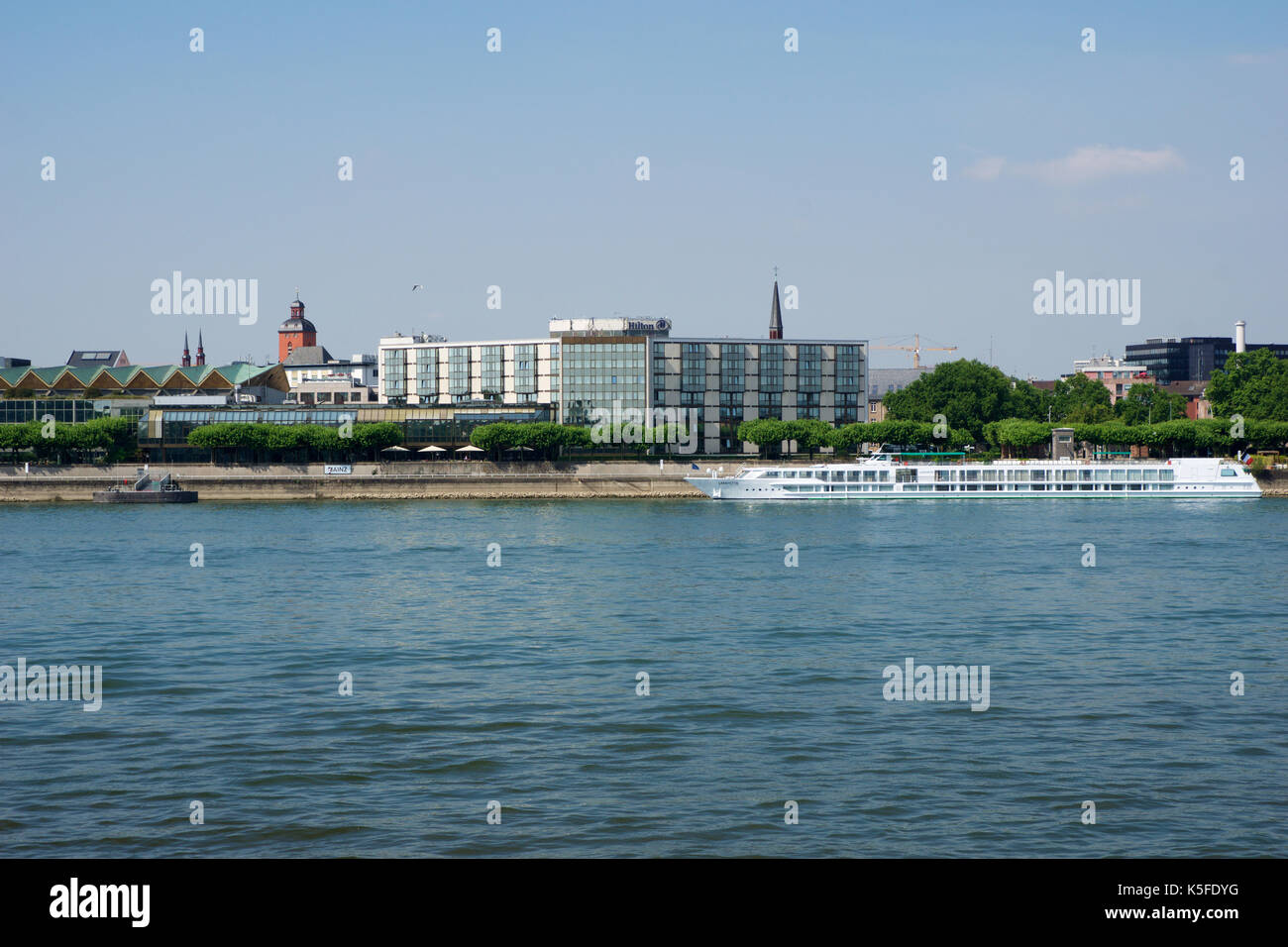MAINZ, GERMANY - JUL 09th, 2017: Luxury Hilton Hotel next to the Rhine german Rhein. Outside view from the opposite river side. Hilton Hotels Resorts is an international chain of full service hotels and resorts of Hilton Worldwide. Stock Photo
