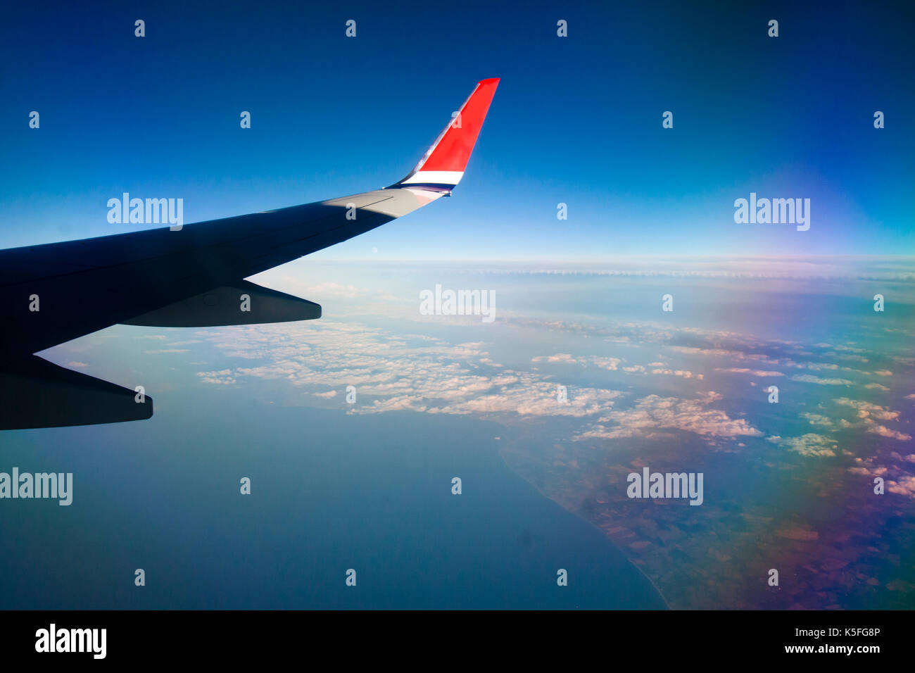 View from airplane window with blue sky and white clouds Stock Photo ...