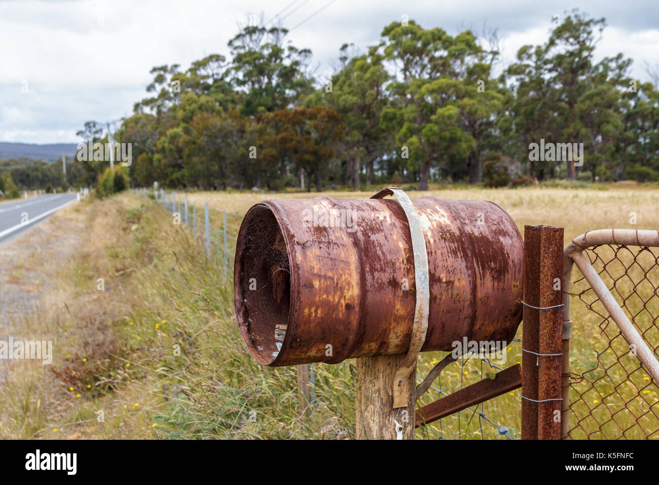 Bruny Island Tasmania, Australia 18 December 2016 rusty rural barrel letterbox on farm gate