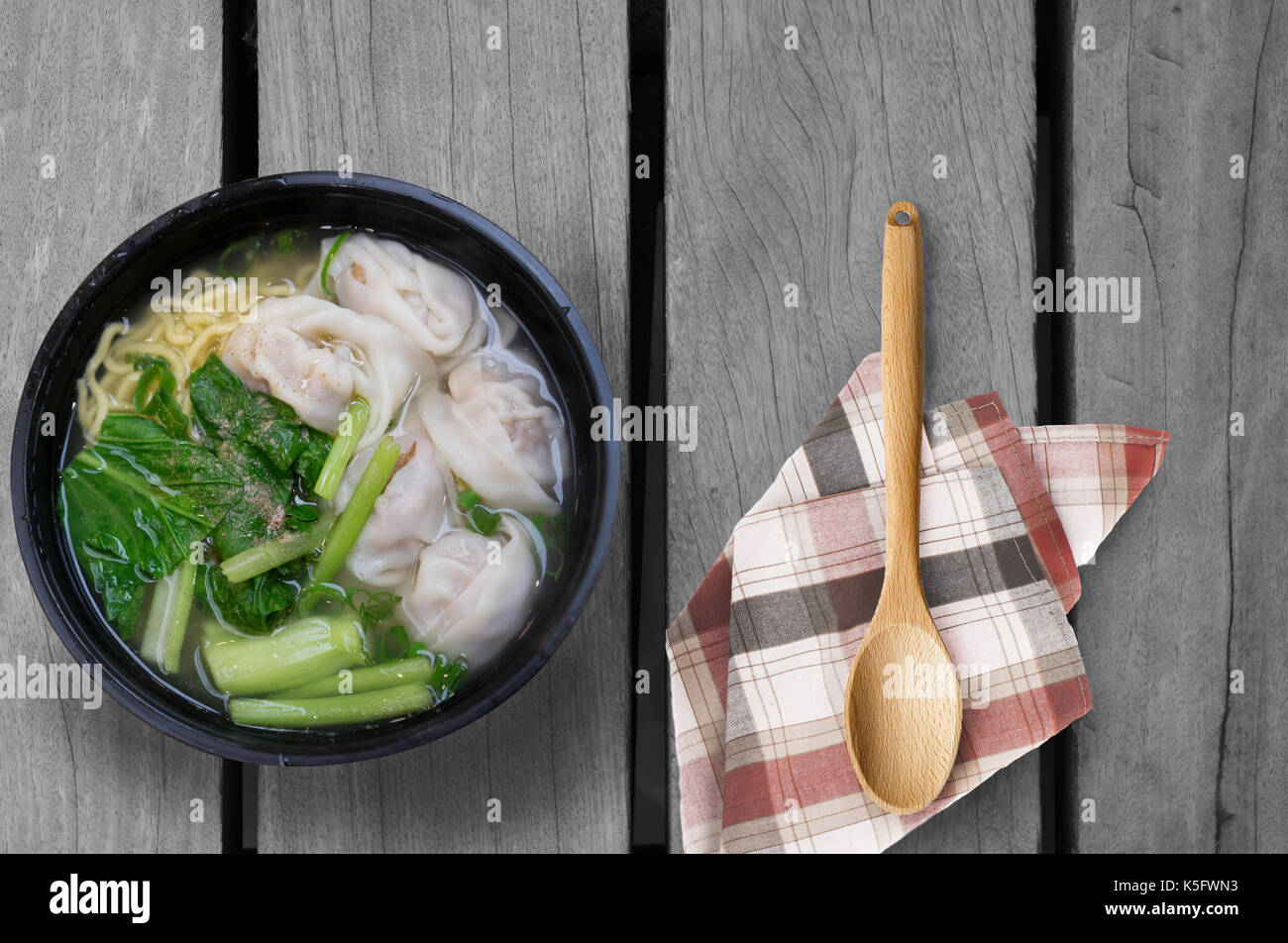 Wonton noodle soup on wooden table Stock Photo