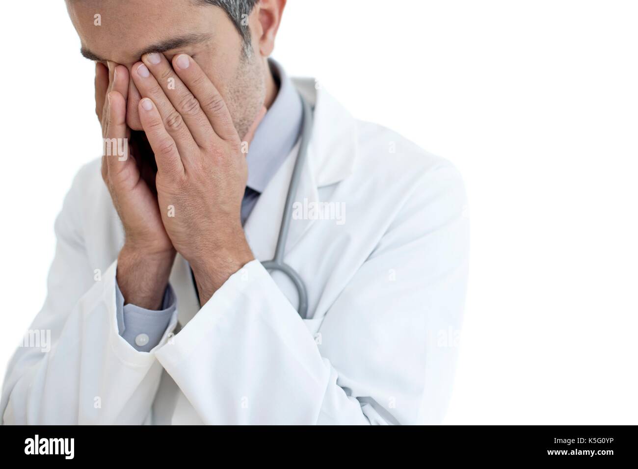 Male doctor rubbing eyes, portrait. Stock Photo