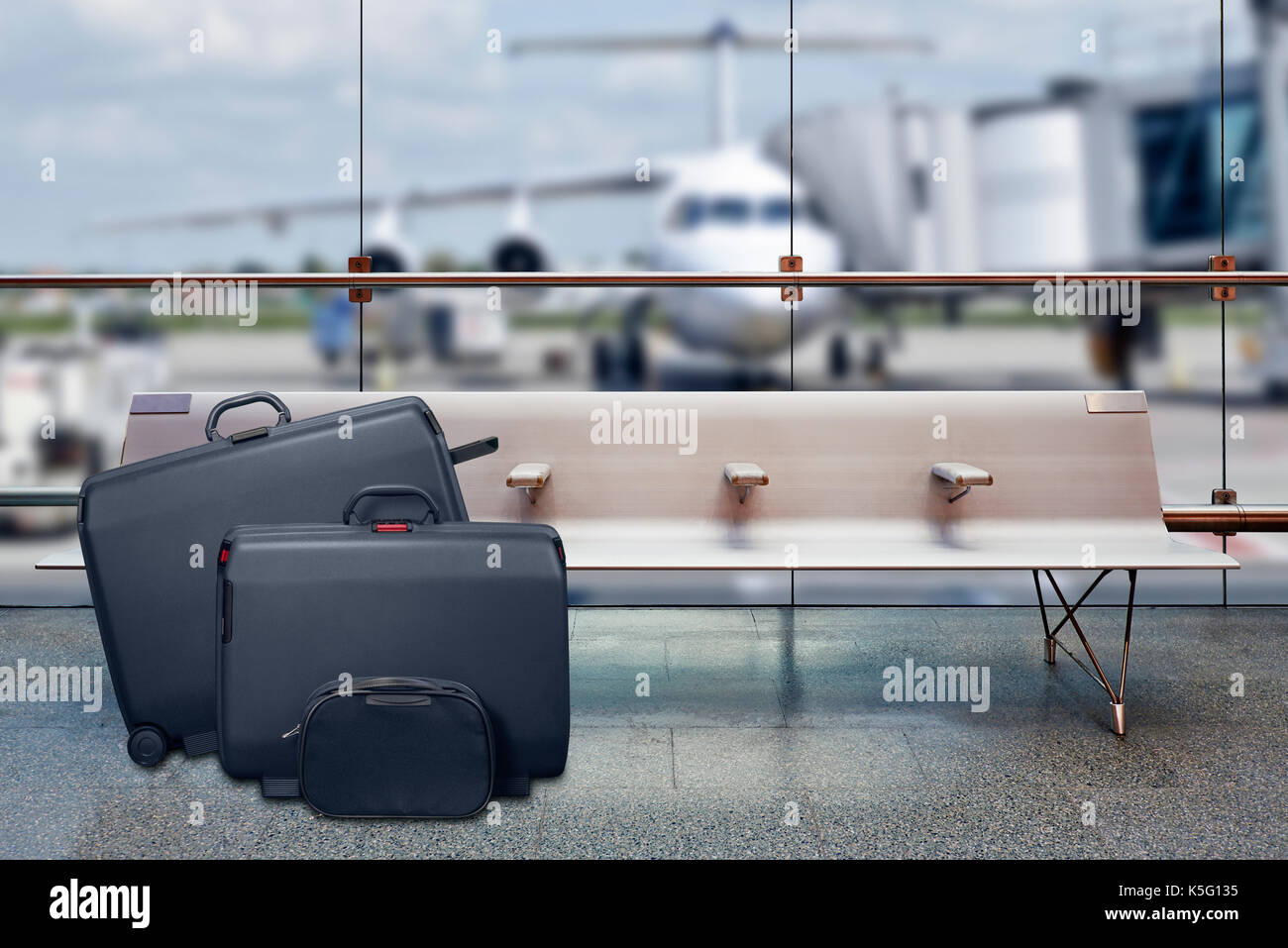 Suitcases in the airport departure lounge, airplane in the blurred