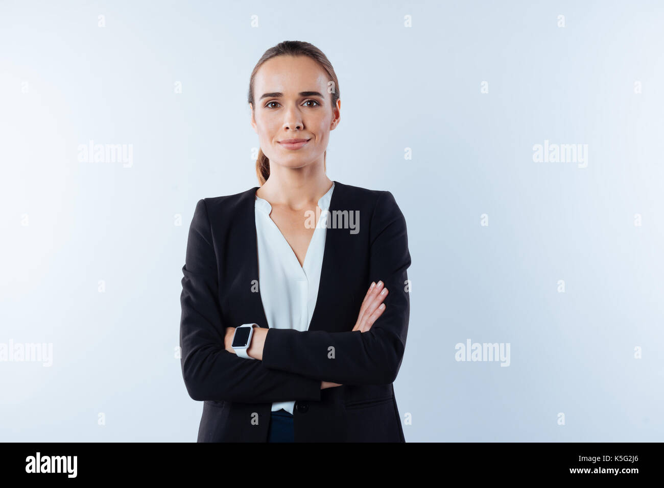 Pleasant confident woman standing cross armed Stock Photo