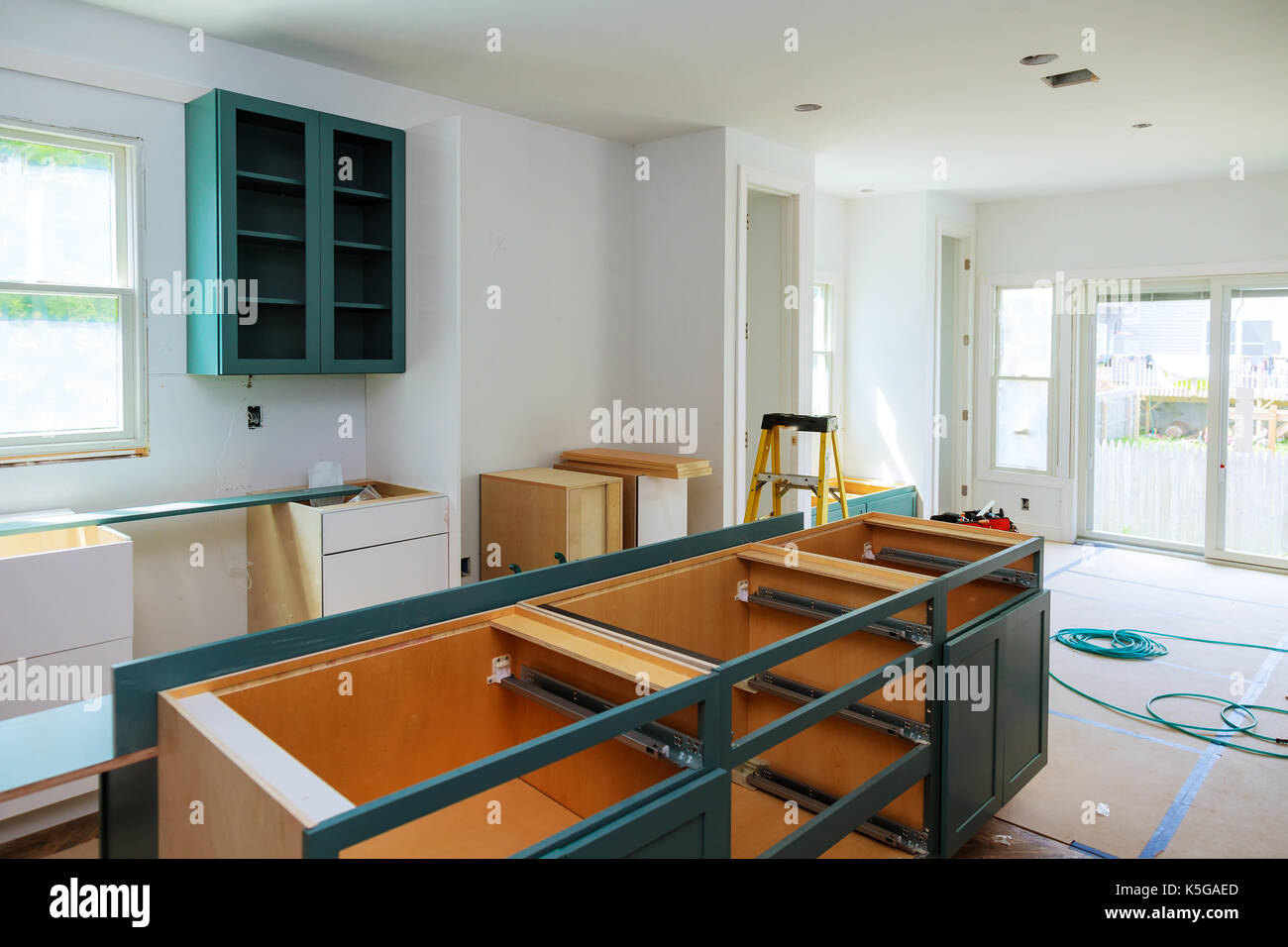 Custom kitchen in various stages of installation base for island in center Installation