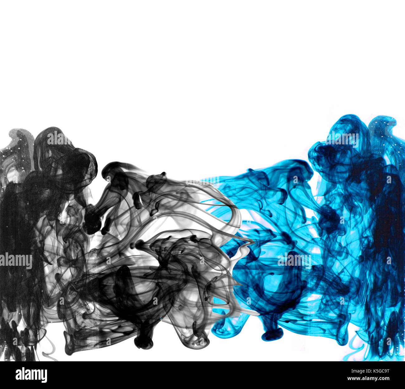 Red color drop in water photographed in motion. Cloud of red ink in ...