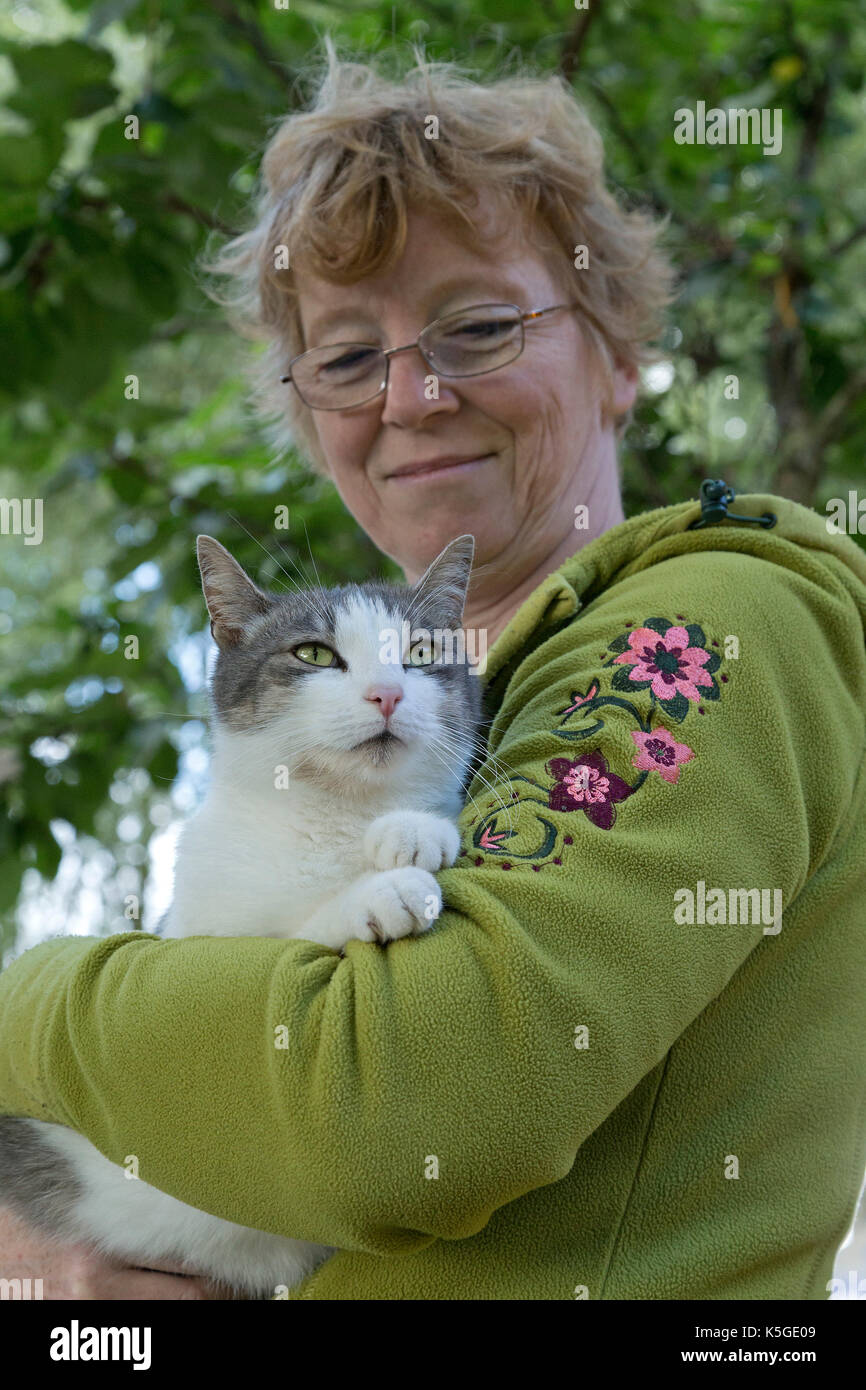 woman cuddling cat Stock Photo