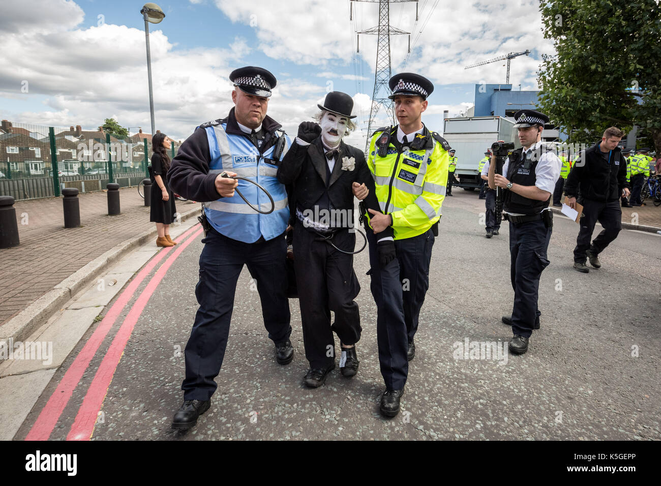 London, UK. 9th Sept, 2017. Police arrest Charlie X, a Chaplin clone who tried to block a lorry at the West Gate of the DSEI arms fair during on-going protests against the DSEi Arms Fair (Defence & Security Equipment International) - the world's largest arms fair at Excel Centre in east London. Credit: Guy Corbishley/Alamy Live News Stock Photo