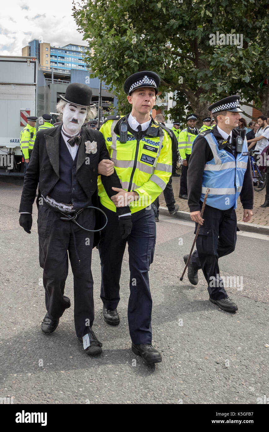 London, UK. 9th Sept, 2017. Police arrest Charlie X, a Chaplin clone who tried to block a lorry at the West Gate of the DSEI arms fair during on-going protests against the DSEi Arms Fair (Defence & Security Equipment International) - the world's largest arms fair at Excel Centre in east London. Credit: Guy Corbishley/Alamy Live News Stock Photo