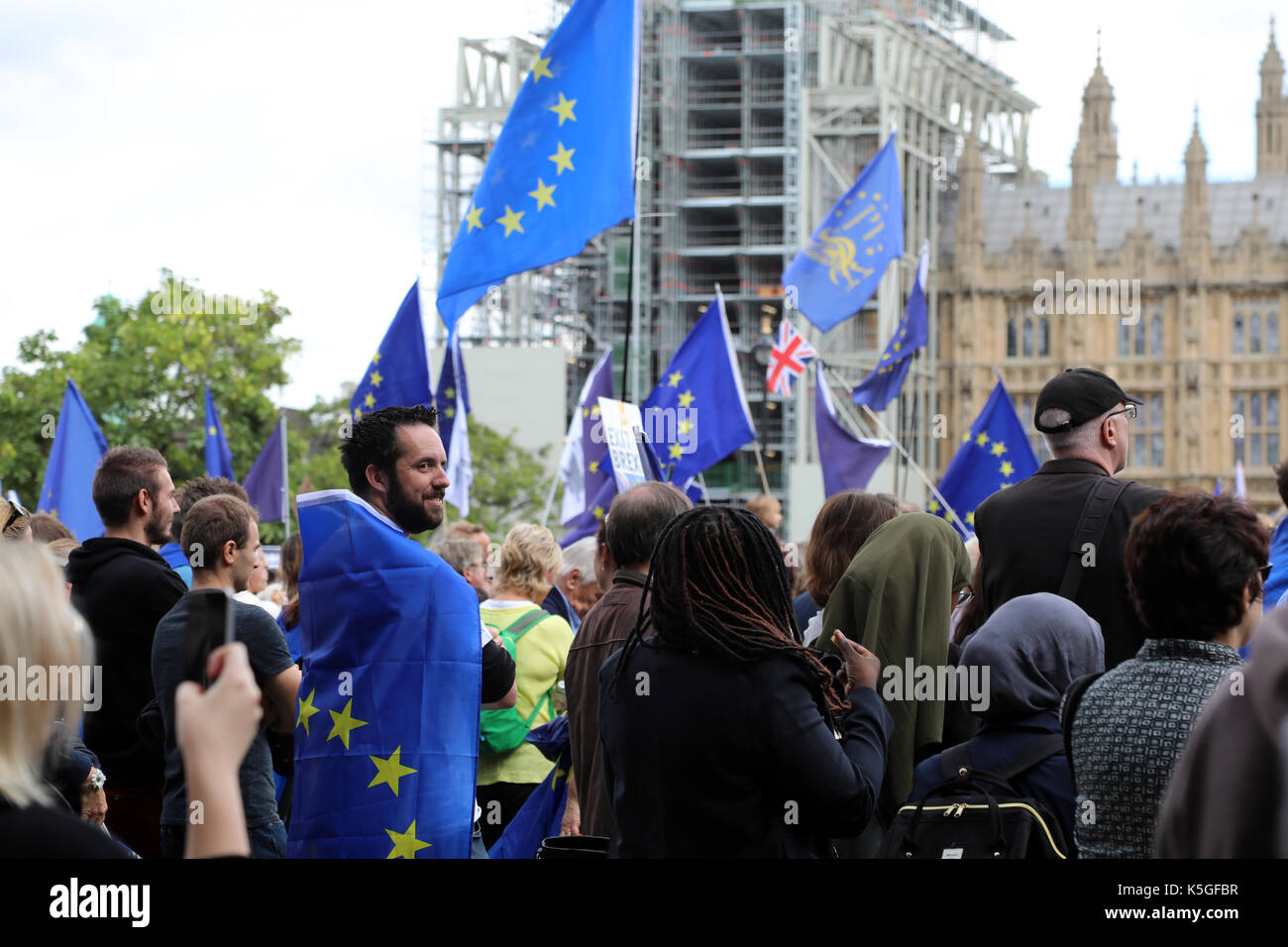 London, UK. 9th Sept, 2017. A man wrapped in an EU flag stands in Parliament Square Garden in Westminster, central London, during the People's March for Europe, an anti-Brexit rally, on 9 September 2017. Credit: Dominic Dudley/Alamy Live News Stock Photo
