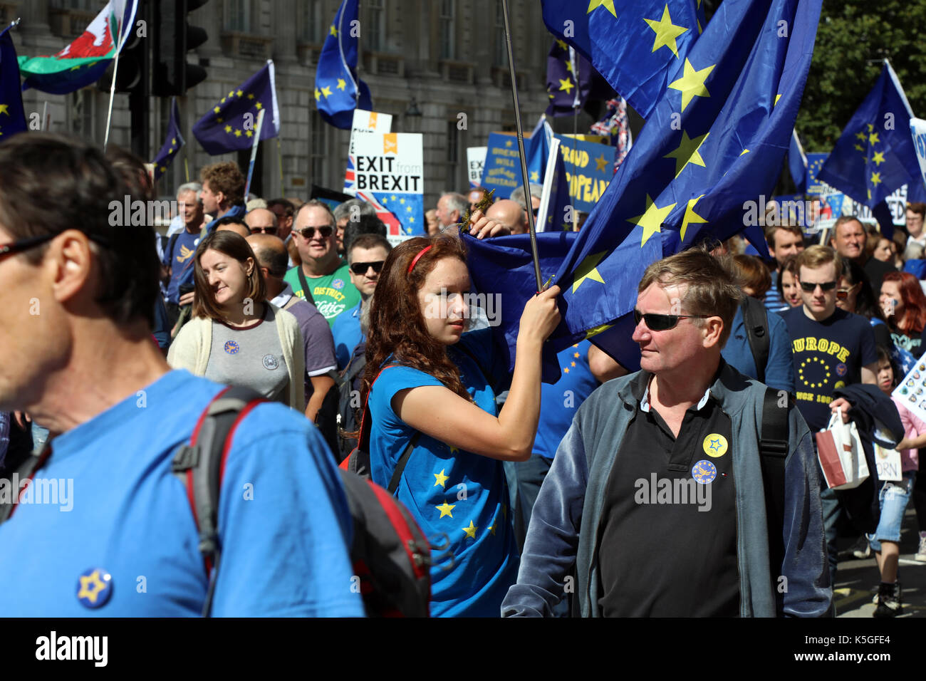 London, UK. 9th Sept, 2017. A young woman grapples with an EU flag while marching down Whitehall during the People's March for Europe, an anti-Brexit rally, on 9 September 2017 Credit: Dominic Dudley/Alamy Live News Stock Photo
