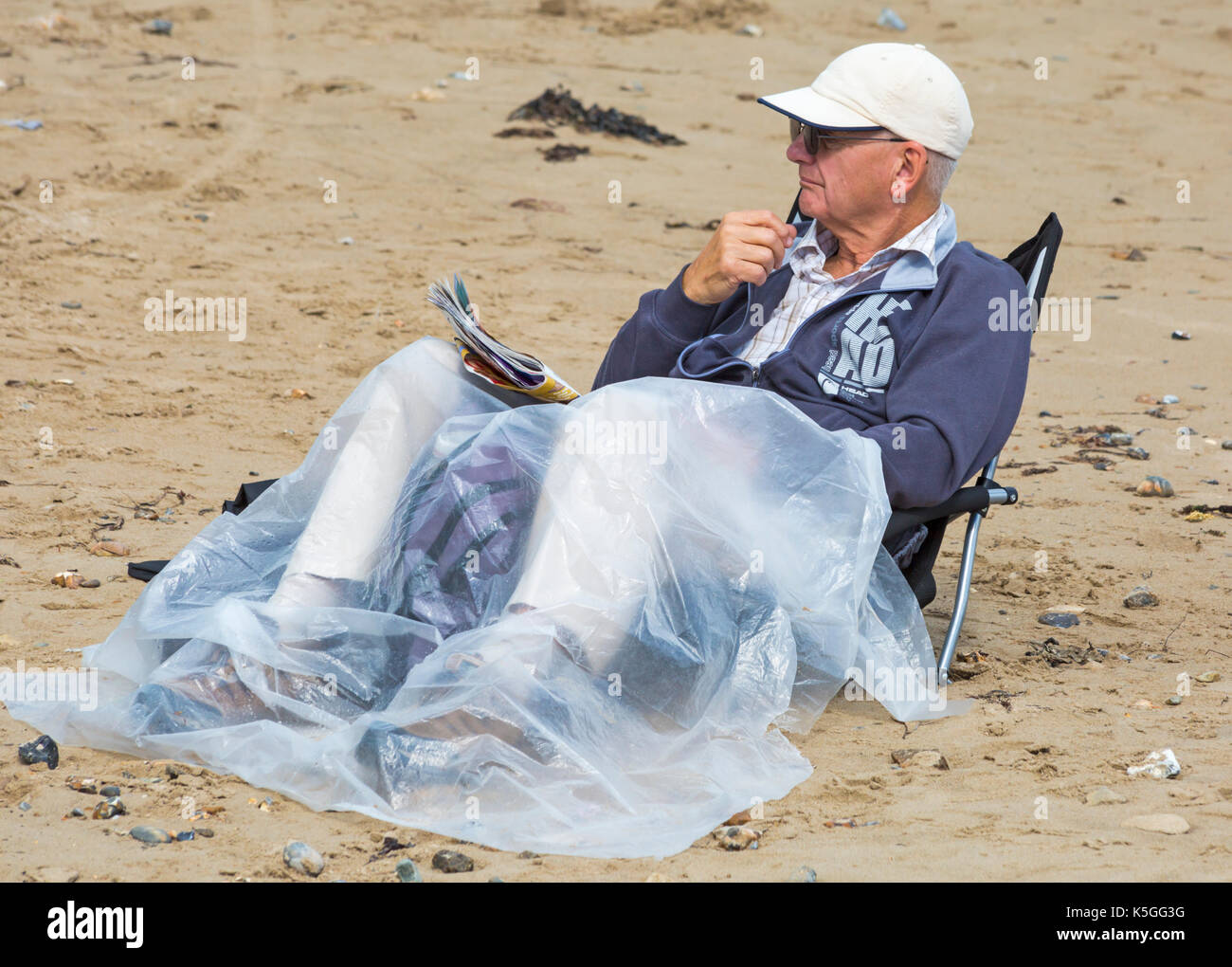 Man sitting on plastic chair hires stock photography and images Alamy