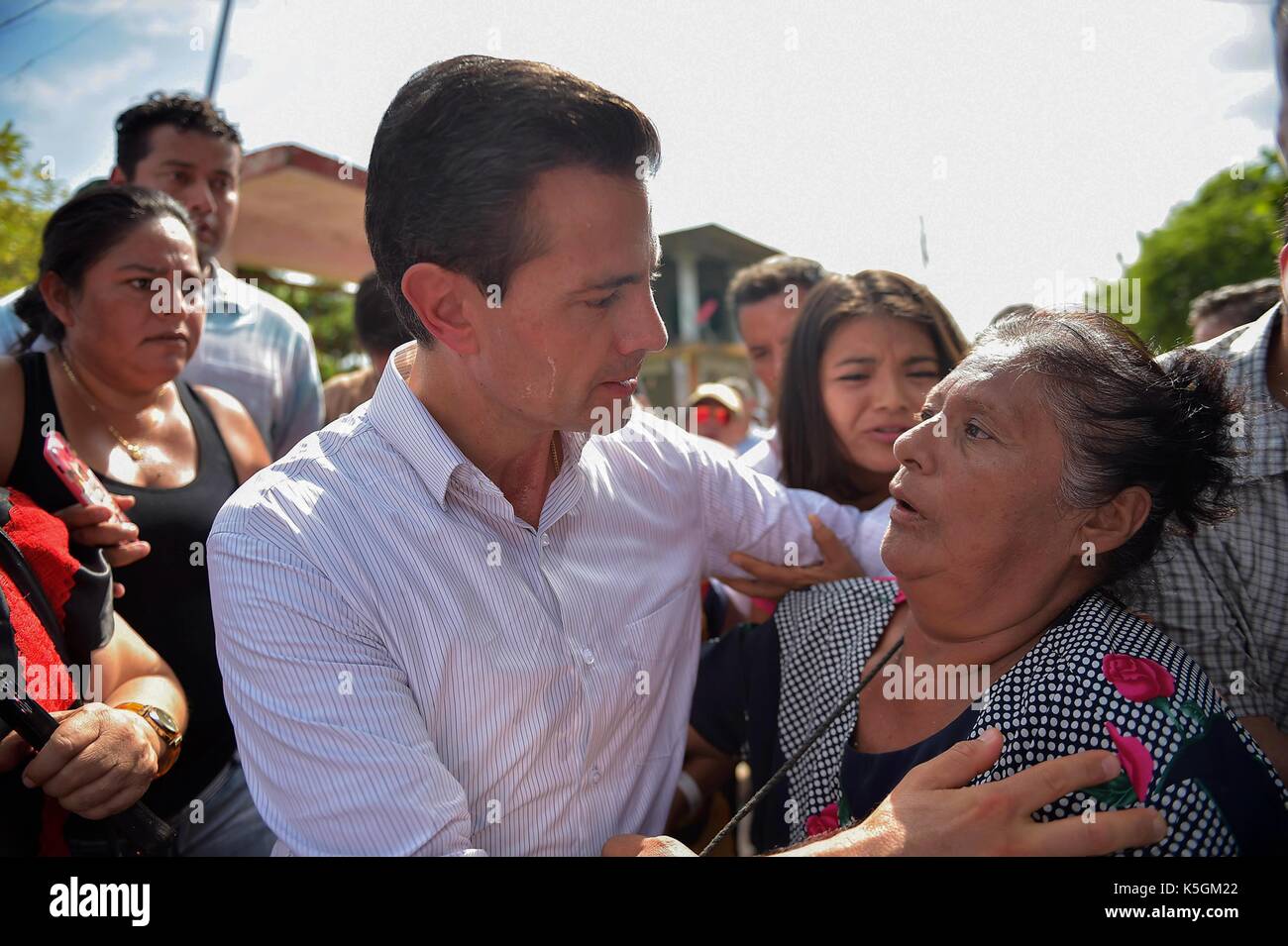 Oaxaca, Mexico. 09th Sep, 2017. Mexican President Enrique Pena Nieto comforts an earthquake survivor during a visit to the coastal town closest to the epicenter September 9, 2017 in Juchitán, Oaxaca, Mexico. The massive 8.2-magnitude quake struck off the southern Pacific coast of Chiapas killing at least 60 people and leveling areas in some southern states. (presidenciamx via Planetpix) Credit: Planetpix/Alamy Live News Stock Photo