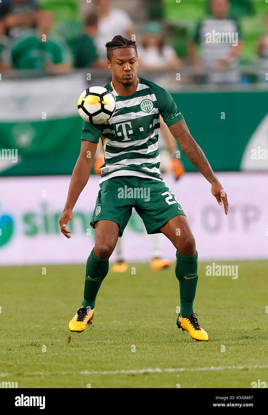 Kenneth Otigba of Ferencvarosi TC tackles Marko Futacs of MOL