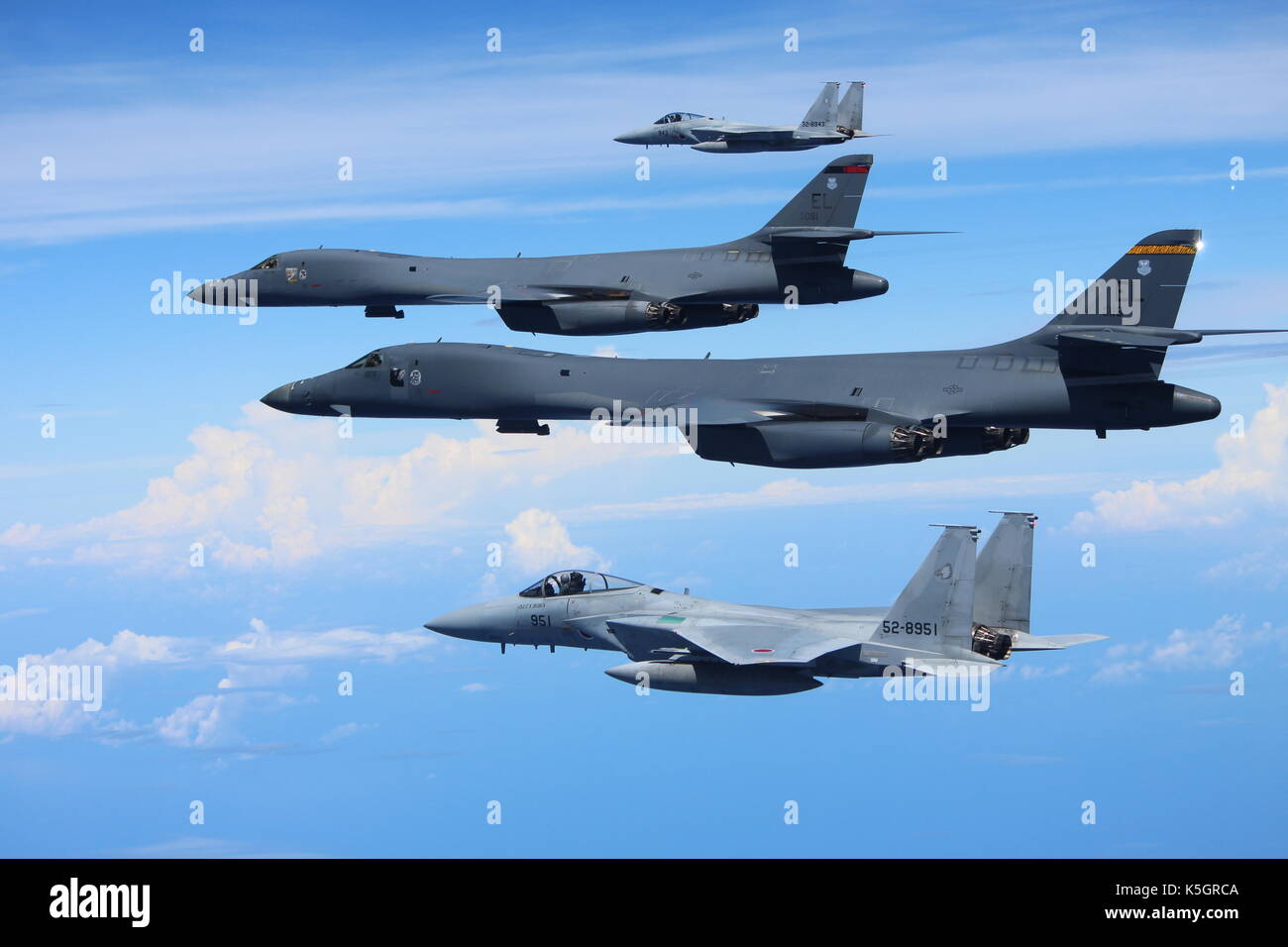 East China Sea, near North Korea. 9th September, 2017. Two U.S. Air Force B-1B Lancer bombers with the 37th Expeditionary Bomb Squadron are escorted by a Japan Air Self-Defense Force F-15 fighter during a joint bilateral patrol as a show of force to North Korea September 9, 2017 over the East China Sea. Credit: Planetpix/Alamy Live News Stock Photo