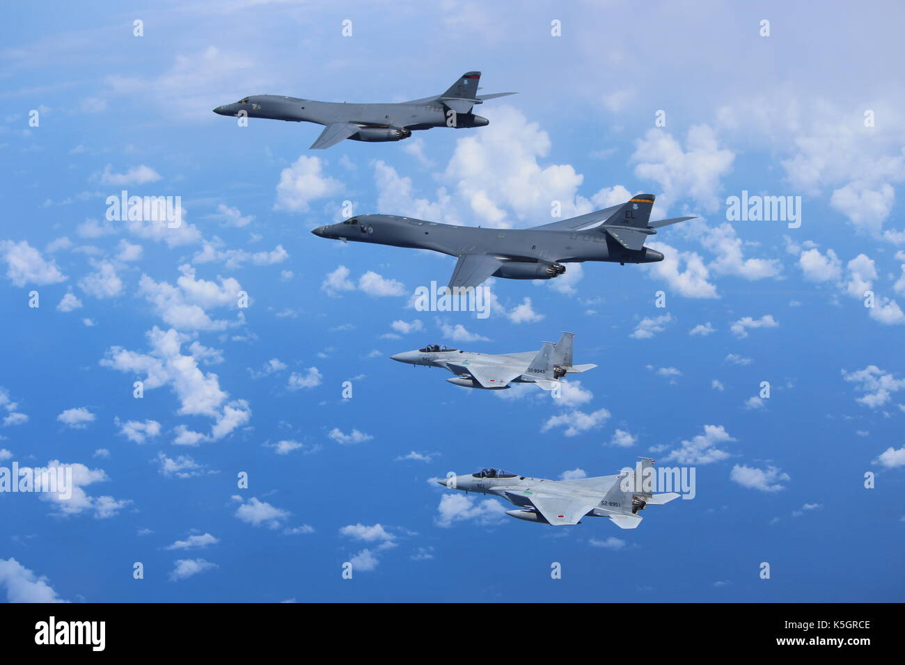 East China Sea, near North Korea. 9th September, 2017. Two U.S. Air Force B-1B Lancer bombers with the 37th Expeditionary Bomb Squadron are escorted by a Japan Air Self-Defense Force F-15 fighter during a joint bilateral patrol as a show of force to North Korea September 9, 2017 over the East China Sea. Credit: Planetpix/Alamy Live News Stock Photo