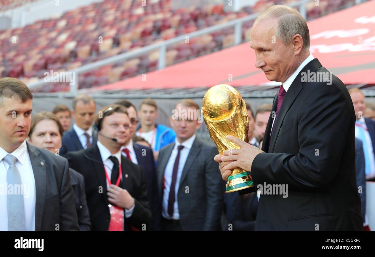 Russian President Vladimir Putin smiles holds the FIFA World Cup Trophy prior to starting the Trophy Tour event at the Luzhniki Grand Sports Arena September 9, 2017 in Moscow, Russia. The FIFA World Cup trophy will visit 24 Russian cities and 50 countries prior to the start of the World Cup Russia 2018. Stock Photo