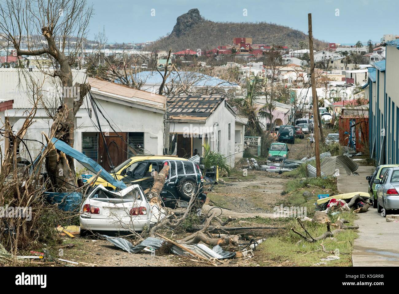 Vehicles and debris from destroyed homes litter the historic district on the Dutch island of St Maarten following a direct hit by Hurricane Irma, a Category 5 storm lashing the Caribbean September 8, 2017 in Philipsburg, St. Maarten. Stock Photo