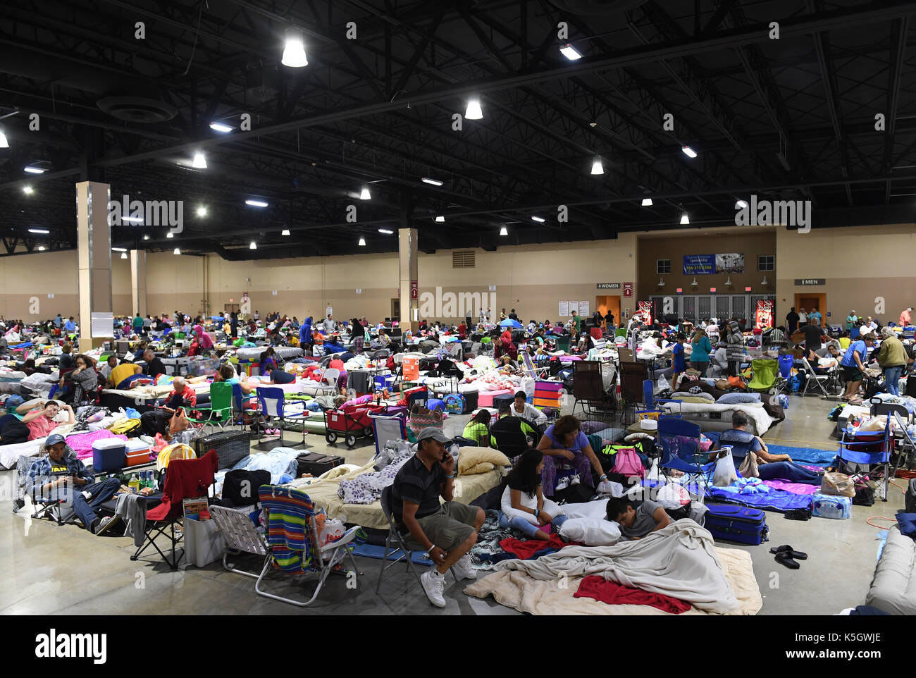 Miami, USA. 9th Sep, 2017. People are seen at a shelter at the Miami-Dade County Fair Expo Center in Miami, as hurricane 'Irma' is approaching, in Miami, Florida, the United States, Sept. 9, 2017. About 5.6 million people in Florida have been ordered to evacuate, while 54,000 Floridians have taken shelter in 320 shelters across Florida. Forecasters expect the hurricane to hit Florida early Sunday morning. Credit: Yin Bogu/Xinhua/Alamy Live News Stock Photo