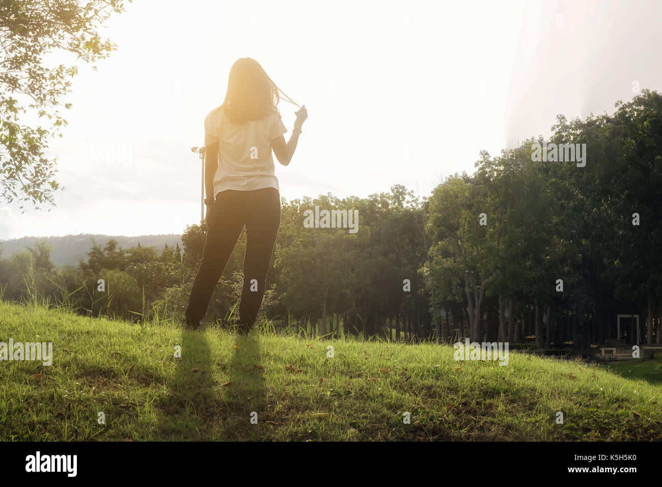 Woman standing alone at the field during beautiful sunset.selective  focus.selective focus Stock Photo - Alamy, image size:1300x956