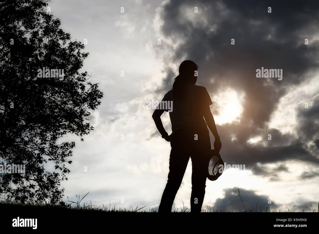 Photo of silhouette adult woman in profile on twilight background. Lonely  woman standing alone moments sunset. Style abstract shadows. Let's Stay  Toge Stock Photo - Alamy