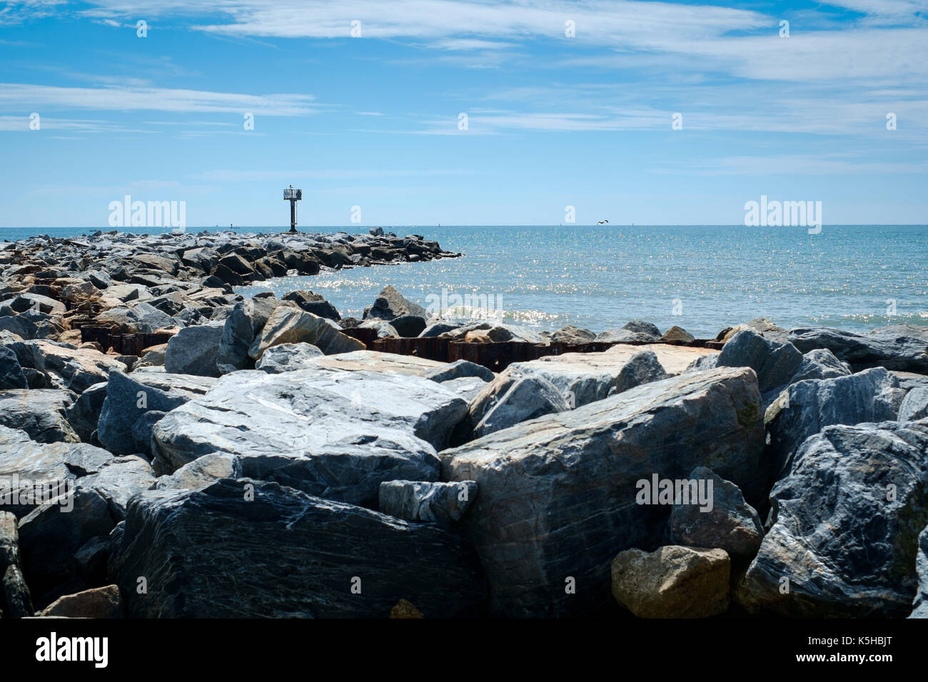 Coastal management with rocks against backdrop of blue sky on Flrida East coast in Summer Stock Photo