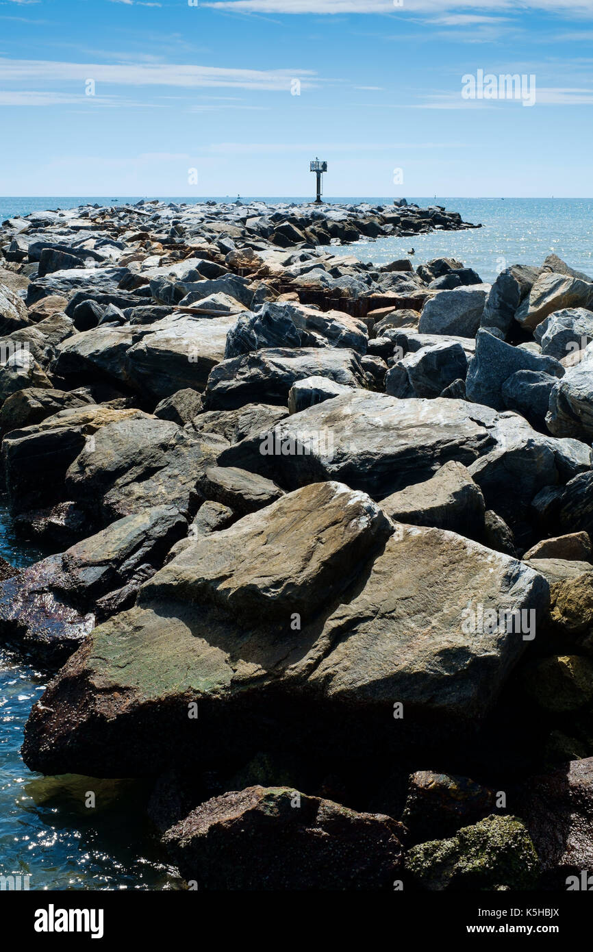 Coastal management with rocks against backdrop of blue sky on Flrida East coast in Summer Stock Photo
