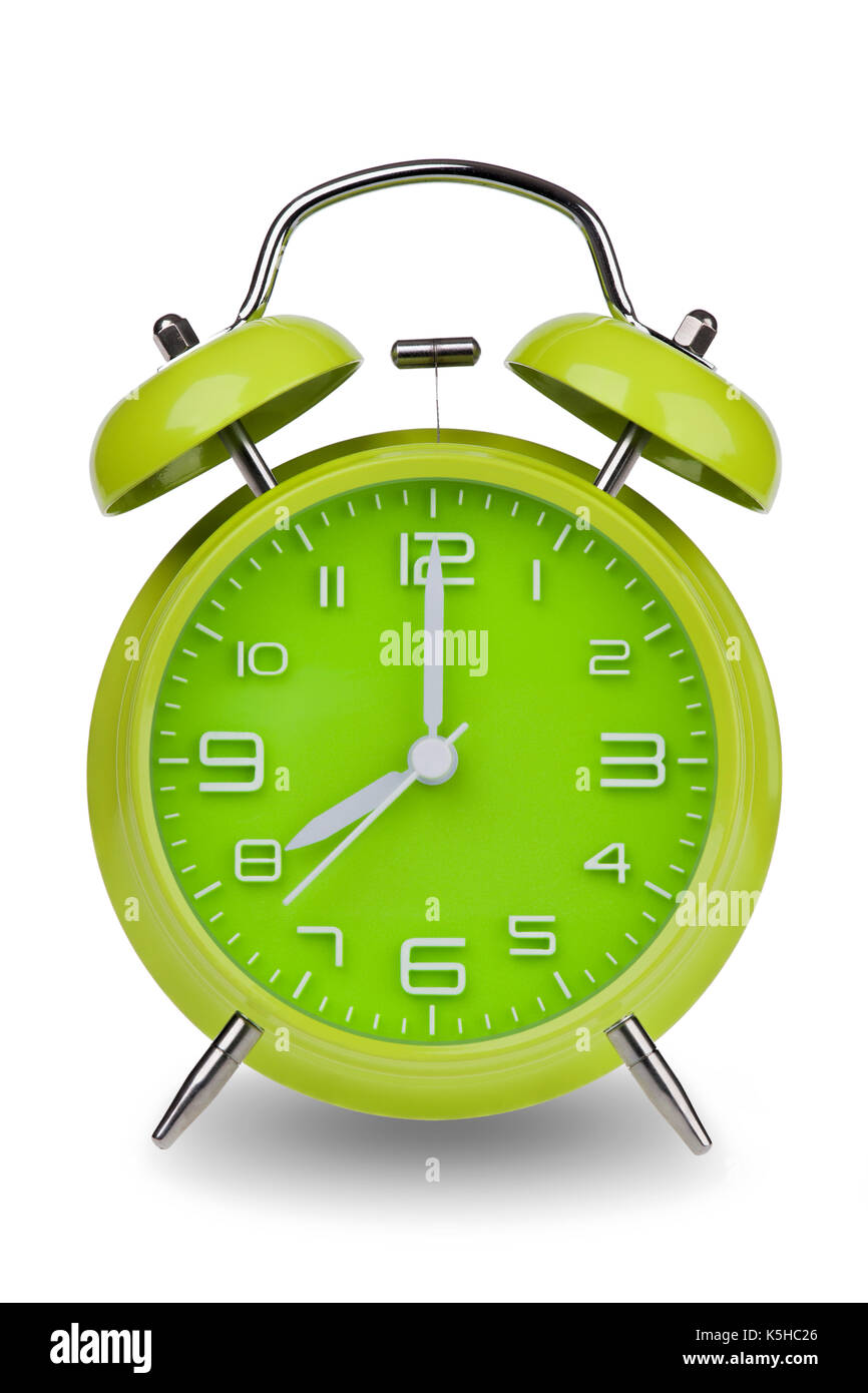 Green alarm clock with the hands at 8 am or pm isolated on a white background with a clipping path. One of a set of 12 images showing the top of the h Stock Photo