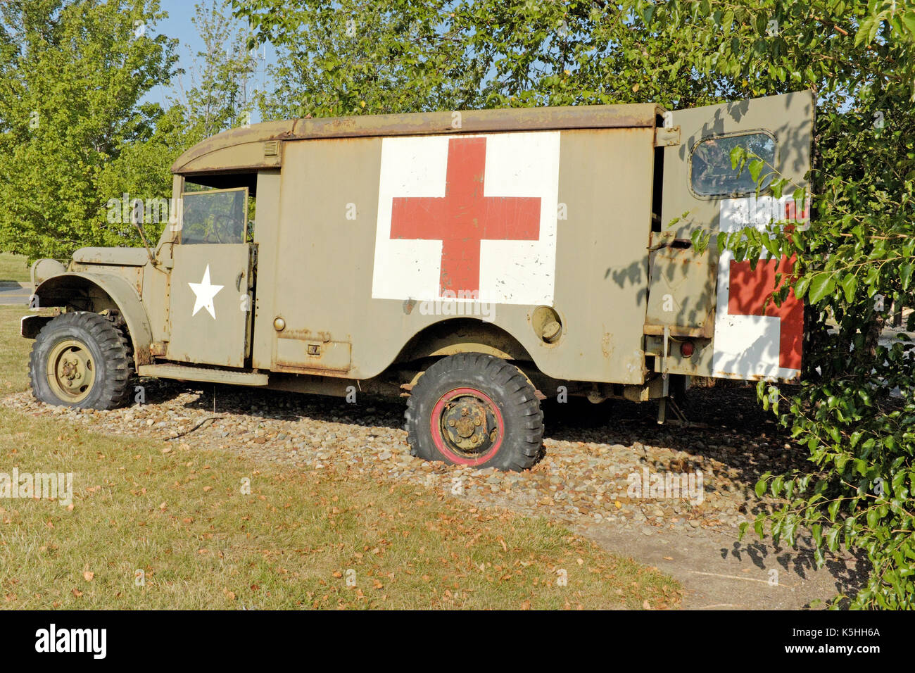 Rusted Red Cross war vehicle sits on display outside in Cleveland, Ohio, USA. Stock Photo